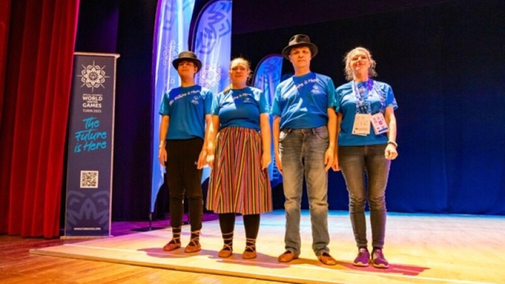 Helen, posing together with her dance partners, Marvin on her right, and Urmas on her left, and Coach Ele. Photo by: Claire Behan.