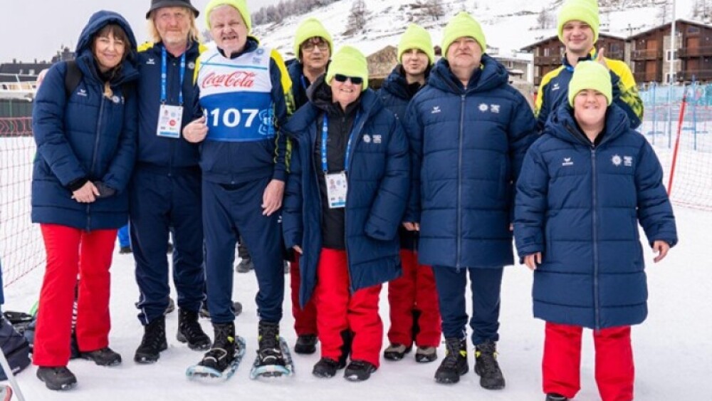 Gerhard poses with his coach, Ernst Lueger, and his fellow Austrian teammates, after competing in Snowshoeing