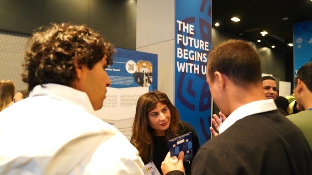 Veronica speaks to the media about the Unified Schools Project at the Global Youth Leadership Summitt: Project Exhibition